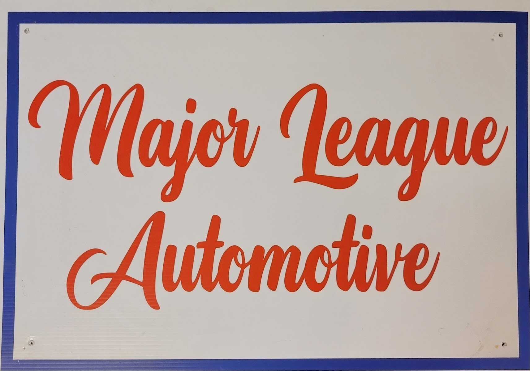 The hand-painted Major League Automotive shop sign in red script.